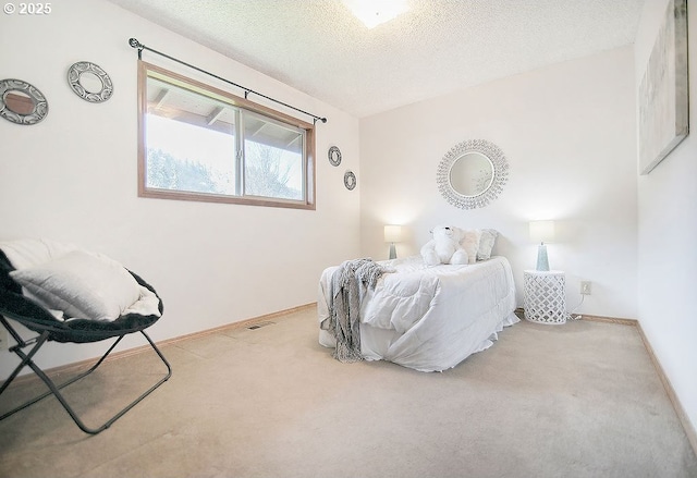 bedroom with a textured ceiling, baseboards, and carpet flooring