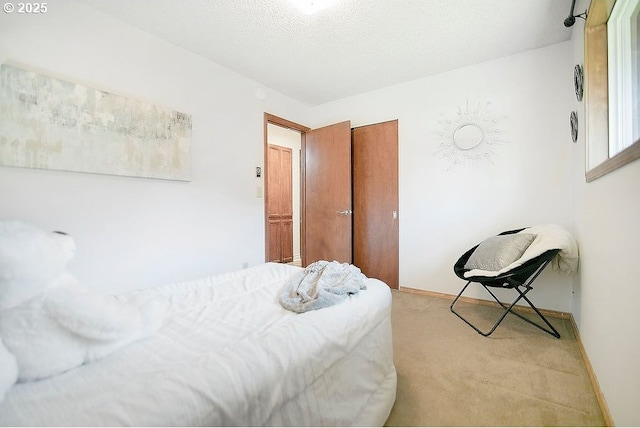 bedroom with a closet, carpet flooring, and a textured ceiling