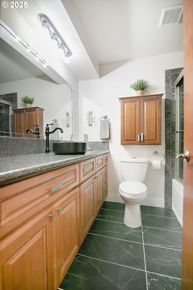 bathroom featuring toilet, marble finish floor, vanity, and visible vents