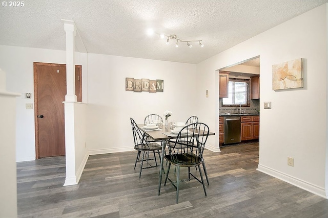 dining area featuring dark wood-style floors, baseboards, and a textured ceiling