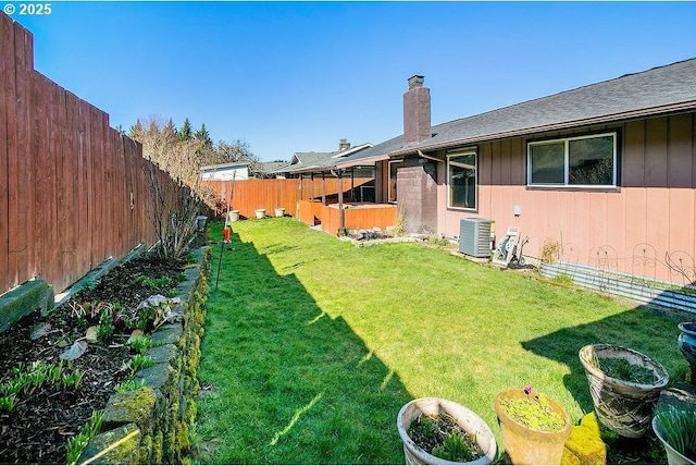 view of yard featuring a fenced backyard and central AC unit