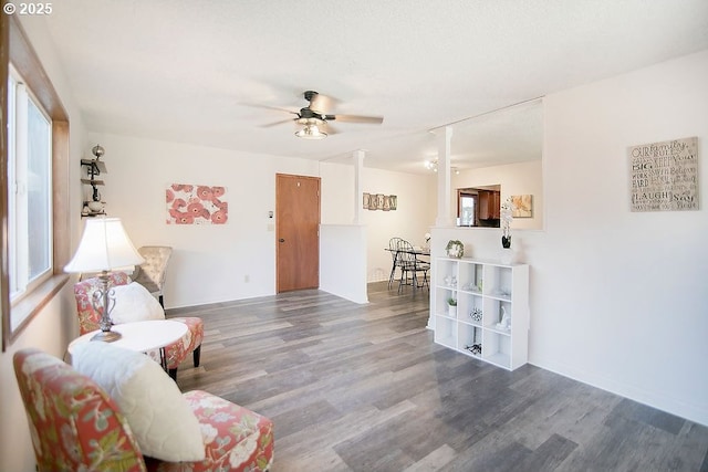 sitting room featuring a ceiling fan and wood finished floors