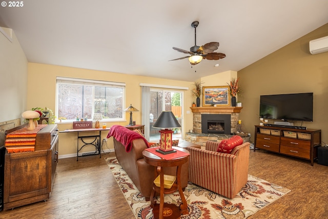 living area featuring lofted ceiling, ceiling fan, a fireplace, wood finished floors, and baseboards
