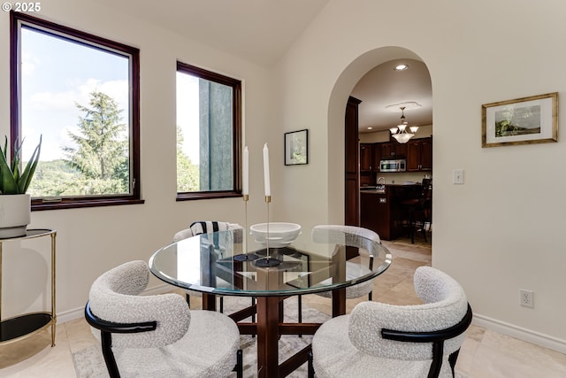 27161 Briggs Hill Rd, Eugene, OR 97405 - dining area featuring arched walkways, lofted ceiling, baseboards, recessed lighting, and a chandelier