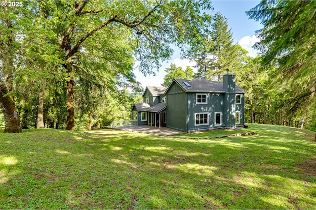 27161 Briggs Hill Rd, Eugene, OR 97405 - rear view of property with a chimney, a patio area, and a yard