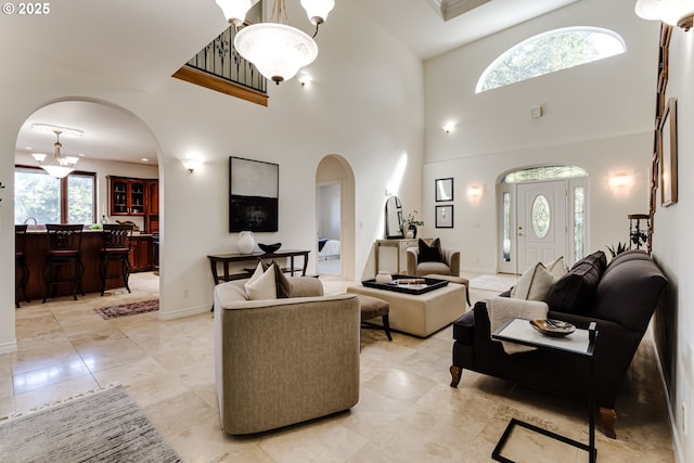 27161 Briggs Hill Rd, Eugene, OR 97405 - living area with arched walkways, a towering ceiling, and baseboards