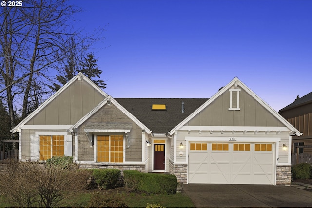 view of front of house with a garage, concrete driveway, board and batten siding, and stone siding