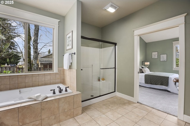 bathroom featuring a wealth of natural light, connected bathroom, and a shower stall