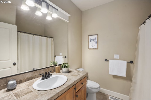 bathroom with toilet, visible vents, baseboards, and vanity