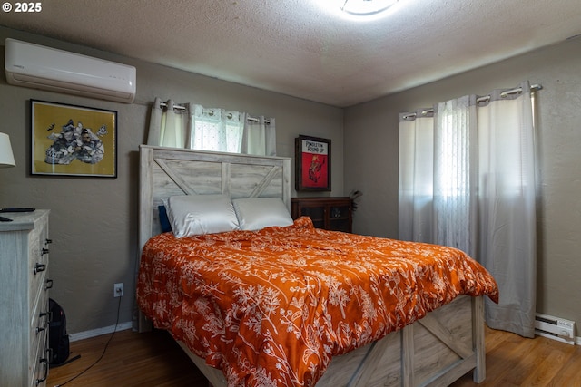 78613 Powerline Rd, Hermiston, OR 97838 - bedroom with a wall mounted AC, wood finished floors, and a baseboard radiator