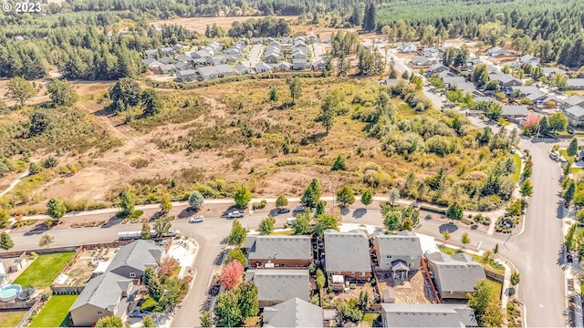 birds eye view of property with a view of trees and a residential view
