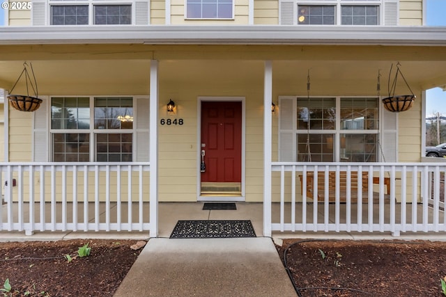 view of exterior entry with covered porch