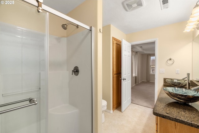 bathroom featuring visible vents, a shower stall, and toilet