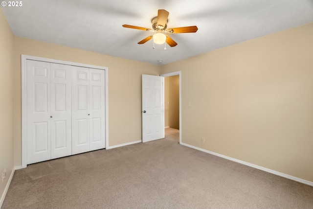 unfurnished bedroom featuring a closet, carpet flooring, ceiling fan, and baseboards