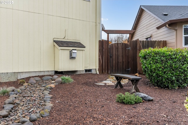 view of side of property featuring a gate and fence