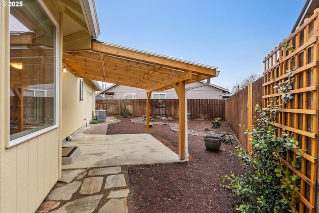 view of patio with central air condition unit and a fenced backyard