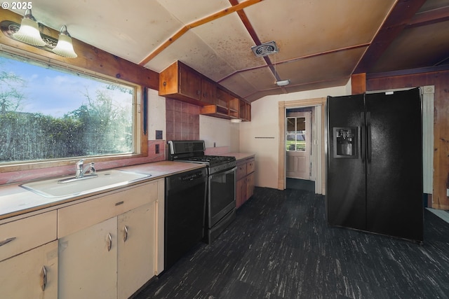 kitchen with tasteful backsplash, lofted ceiling, sink, and black appliances