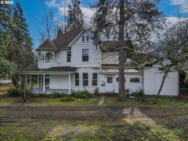 view of front of property with a balcony, ac unit, and covered porch