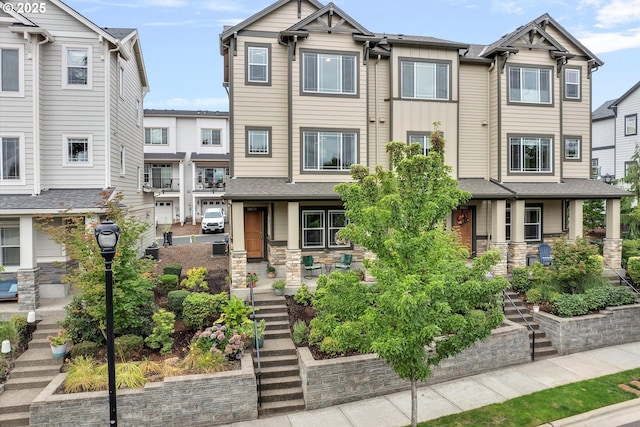 28671 SW Orleans Ave, Wilsonville, OR 97070 - view of front of home with a porch, stone siding, and stairs