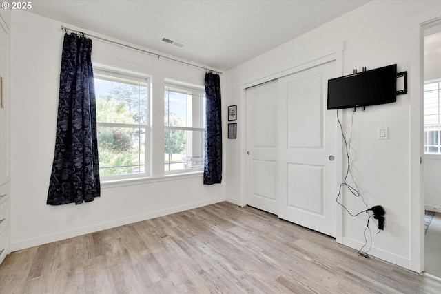 28671 SW Orleans Ave, Wilsonville, OR 97070 - unfurnished bedroom with light wood-style flooring, baseboards, and a closet