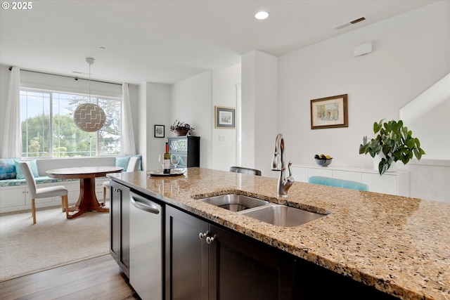 28671 SW Orleans Ave, Wilsonville, OR 97070 - kitchen with a sink, light stone countertops, pendant lighting, light wood-type flooring, and recessed lighting