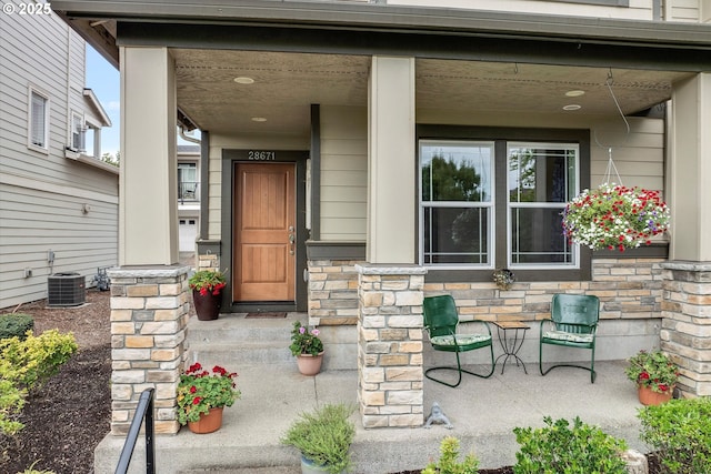 28671 SW Orleans Ave, Wilsonville, OR 97070 - entrance to property featuring a porch, stone siding, and central AC unit