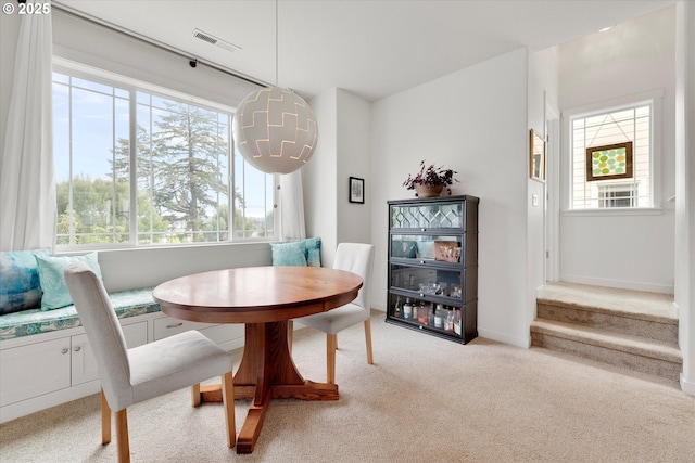 28671 SW Orleans Ave, Wilsonville, OR 97070 - dining room with healthy amount of natural light, light carpet, breakfast area, and stairs