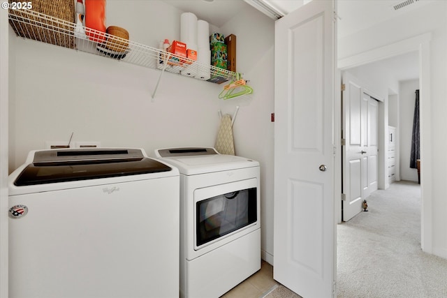 28671 SW Orleans Ave, Wilsonville, OR 97070 - laundry room featuring washing machine and clothes dryer and light colored carpet