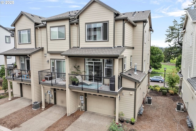 28671 SW Orleans Ave, Wilsonville, OR 97070 - townhome / multi-family property with a garage, driveway, a shingled roof, and a balcony