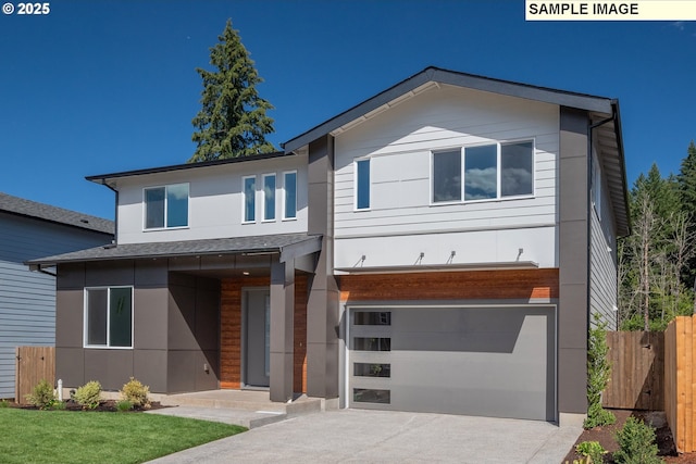 modern home with driveway, a front lawn, a garage, and fence