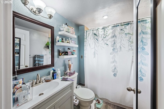 bathroom with a shower with shower curtain, toilet, vanity, and a textured ceiling