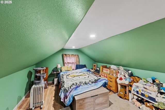 bedroom featuring vaulted ceiling, wood finished floors, and baseboards