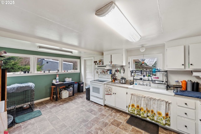 kitchen featuring white cabinets, white electric stove, and light countertops