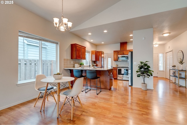 dining room with light wood-type flooring and plenty of natural light