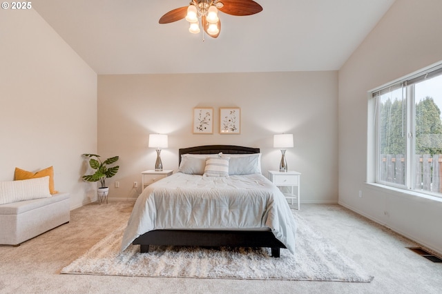 bedroom with baseboards, visible vents, lofted ceiling, ceiling fan, and carpet flooring