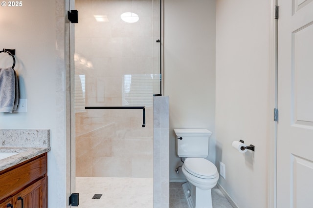 full bathroom with a stall shower, baseboards, toilet, tile patterned floors, and vanity