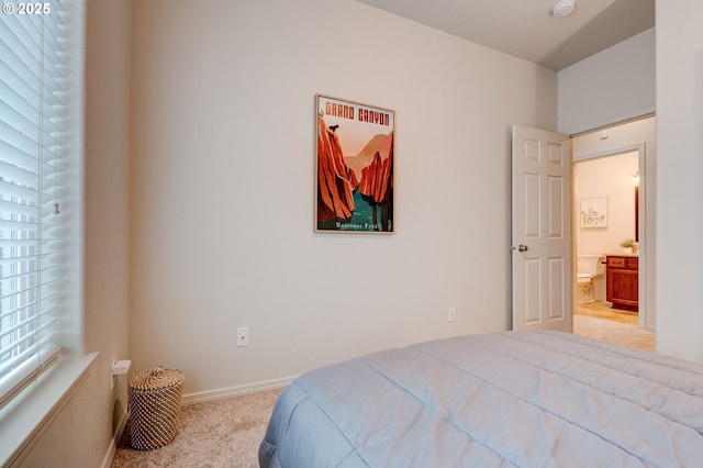 bedroom featuring light carpet and baseboards