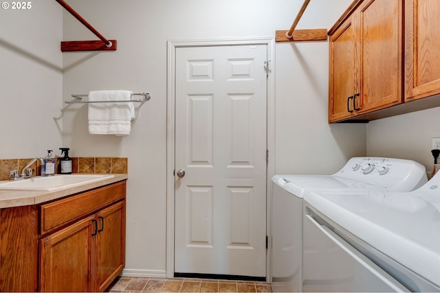 laundry room featuring washer and dryer, cabinet space, and a sink