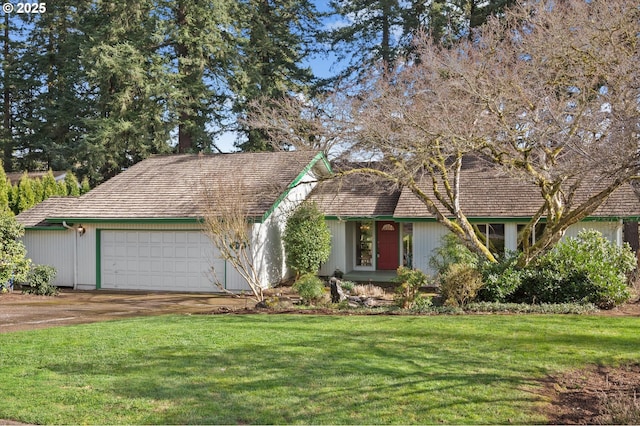 view of front of house with a front yard, driveway, and an attached garage