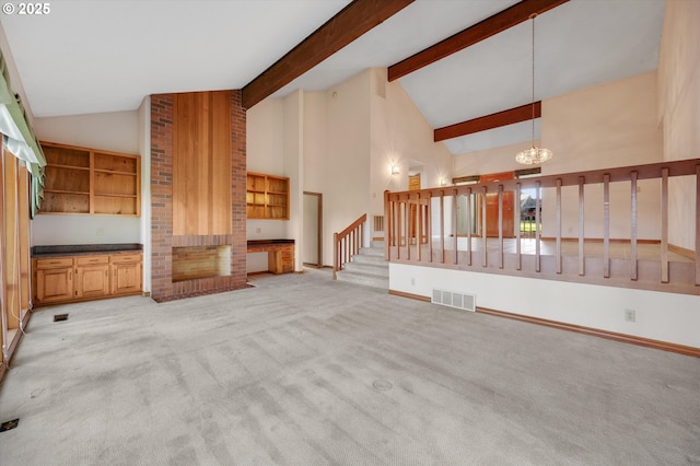 unfurnished living room with light colored carpet, visible vents, a brick fireplace, a chandelier, and stairs