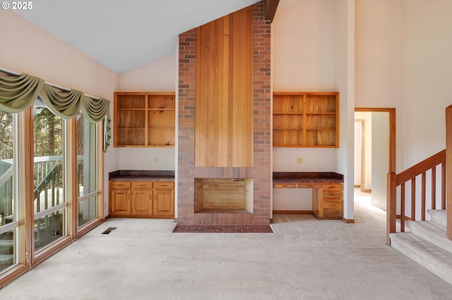 interior space with dark countertops, open shelves, and light colored carpet