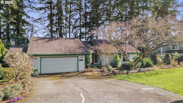 view of front of property featuring concrete driveway, a front lawn, a chimney, and an attached garage