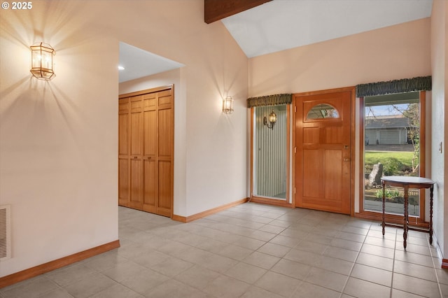 tiled foyer entrance with lofted ceiling with beams and baseboards