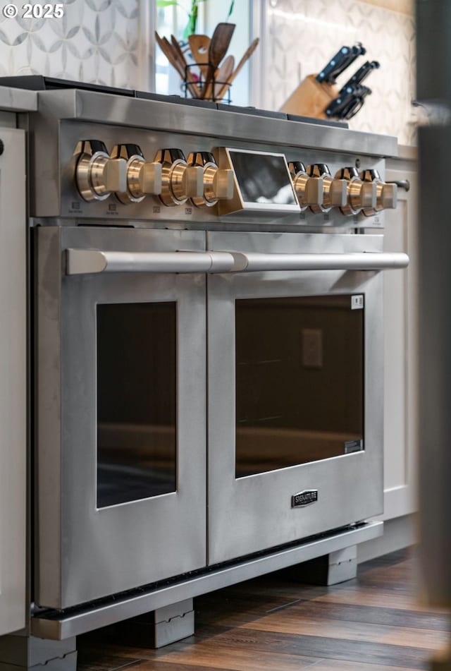 interior details featuring wood finished floors and double oven range