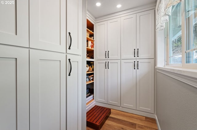 mudroom featuring light wood-style flooring, baseboards, and recessed lighting