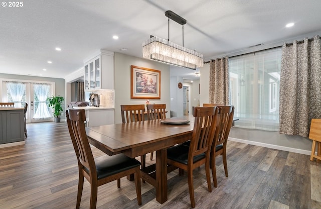 dining space with recessed lighting, dark wood finished floors, visible vents, and baseboards