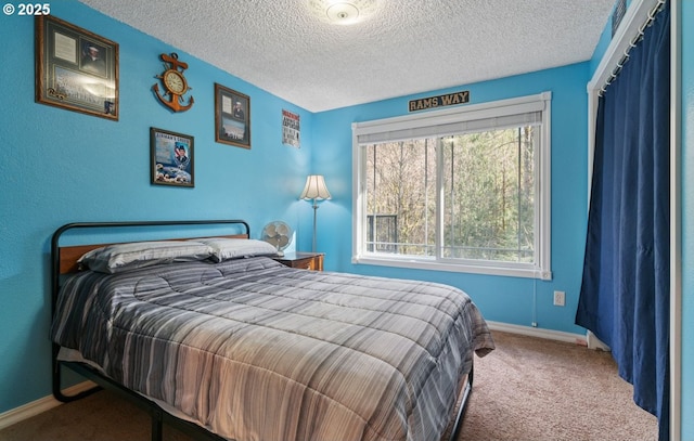 bedroom with carpet, a textured ceiling, and baseboards