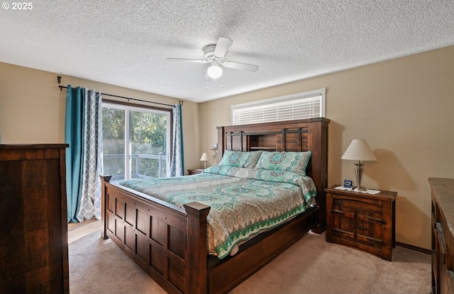 bedroom featuring a ceiling fan, light colored carpet, and a textured ceiling