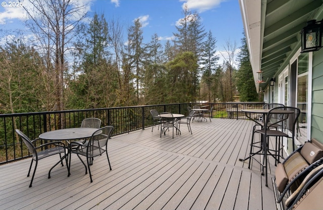 deck with outdoor dining area