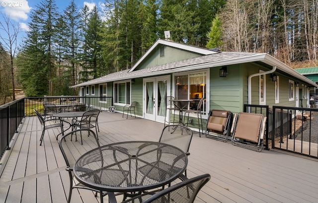 wooden terrace featuring outdoor dining area and french doors